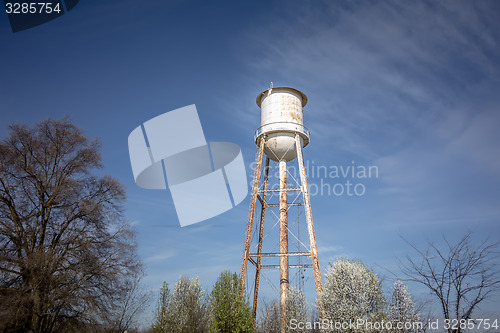 Image of Tall  water tower with cloudy blue sky background