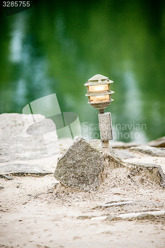 Image of mood lighting light fixture on rocks by the water