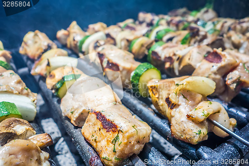 Image of shish kebab on skewers on a grill on a holiday