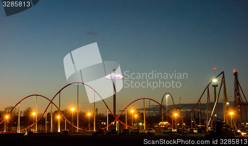 Image of sunset over an amusement park in a distance