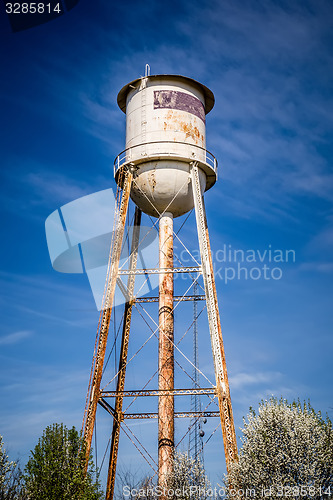 Image of Tall  water tower with cloudy blue sky background