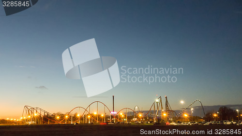 Image of sunset over an amusement park in a distance