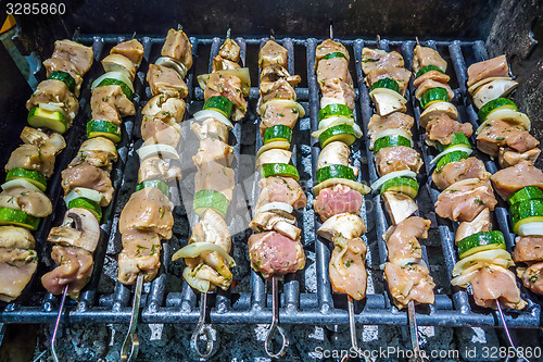 Image of shish kebab on skewers on a grill on a holiday