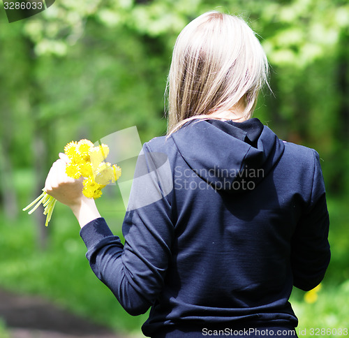 Image of woman with dandelions