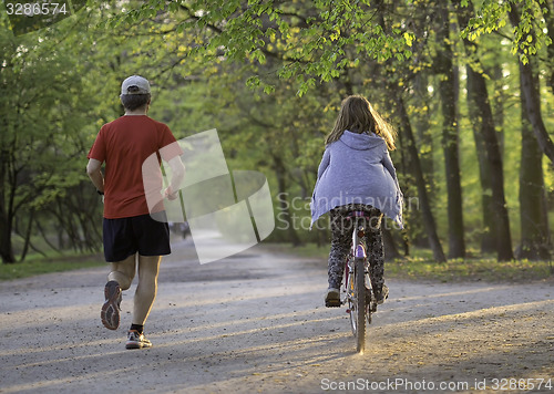Image of Dad with daughter on bike 