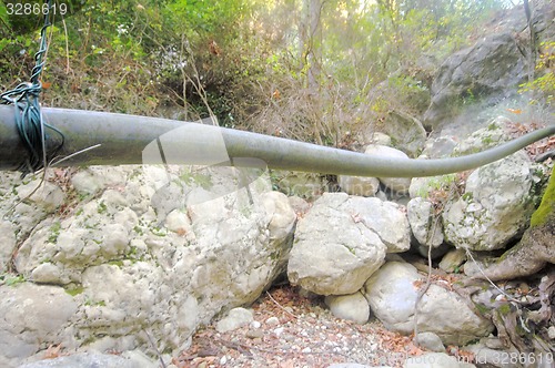 Image of Plastic pipe hanging over the land like a snake