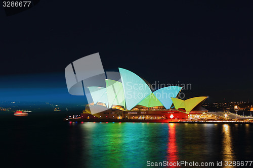 Image of Sydney Opera House illuminated ilight green and aqua