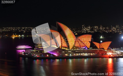 Image of Sydney Opera House in burnt orange and yellow Vivid Sydney