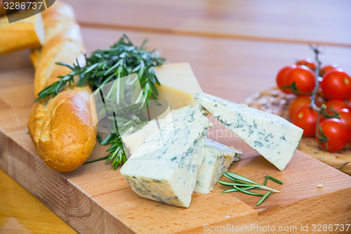 Image of Cheese and bread on the wooden board