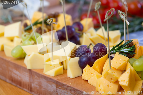 Image of Cheese and grape on the wooden board