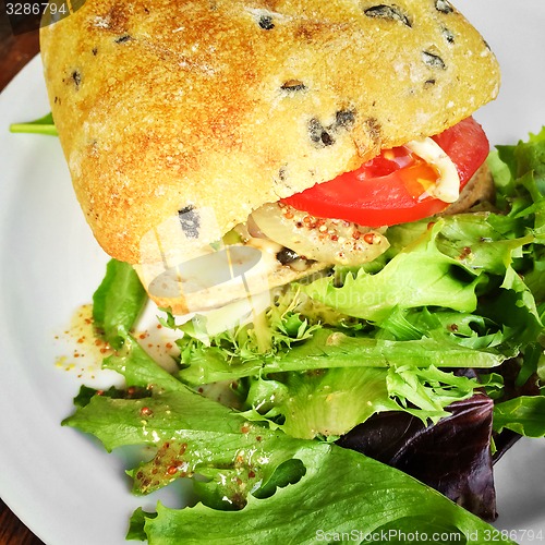 Image of Hamburger with ciabatta bread and salad