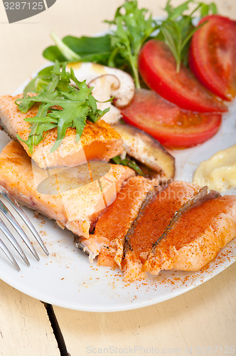 Image of grilled samon filet with vegetables salad