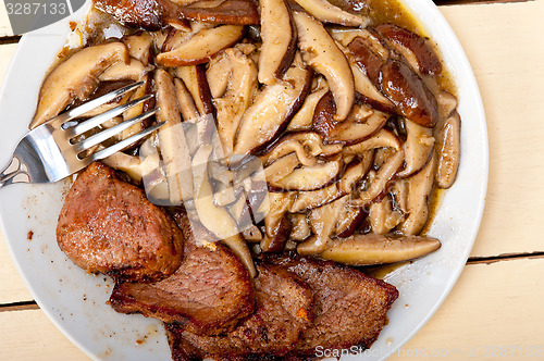 Image of venison deer game filet and wild mushrooms