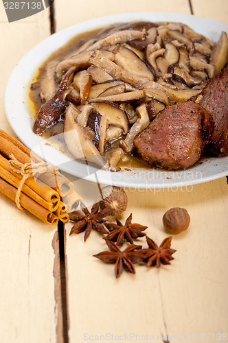 Image of venison deer game filet and wild mushrooms