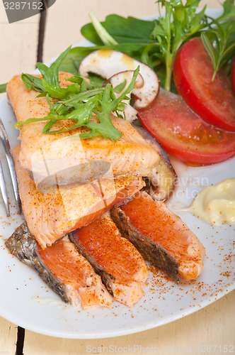 Image of grilled samon filet with vegetables salad