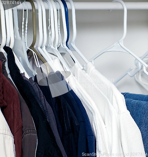 Image of shirts hanging in closet