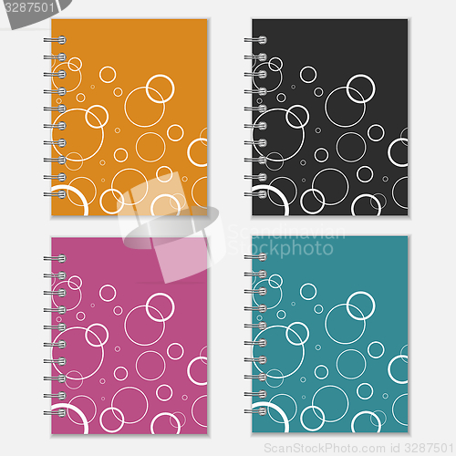 Image of Set of four colorful notebook covers with white circles