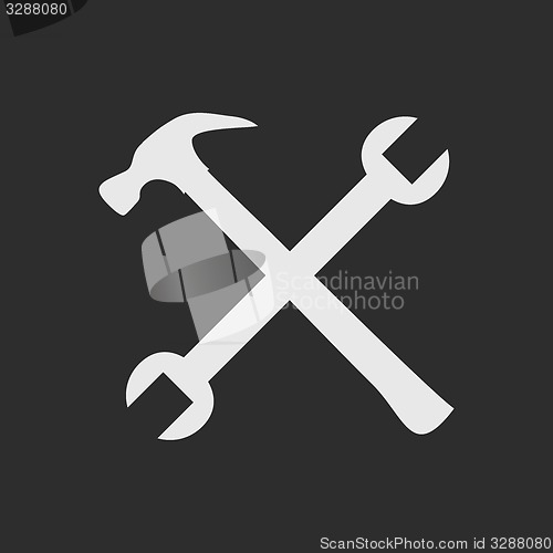 Image of Crossed white tools on dark grey background