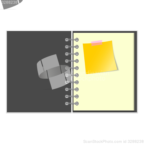 Image of Open grey cover notebook with yellow sticker