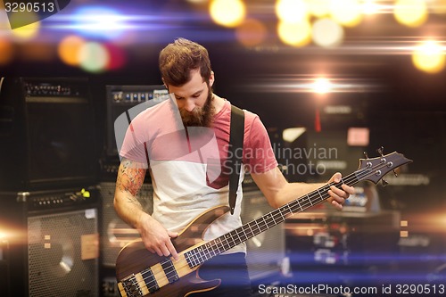 Image of musician or customer with guitar at music store