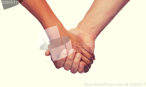 Image of woman and man holding hands