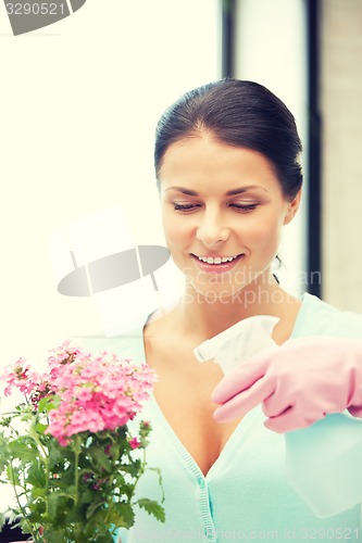 Image of lovely housewife with flower