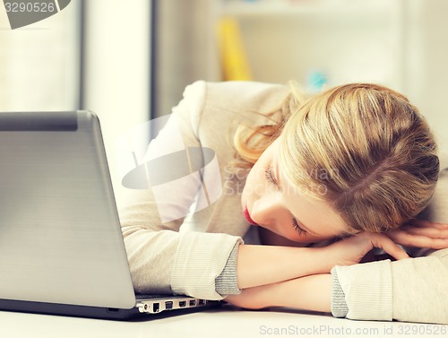 Image of bored and tired woman sleeping on the table