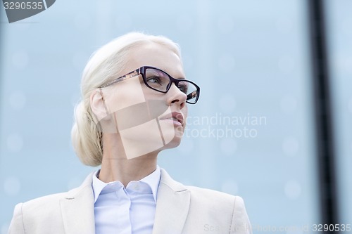 Image of young businesswoman over office building