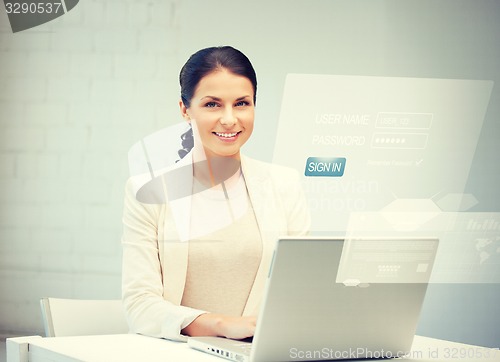 Image of woman with laptop computer and virtual screen