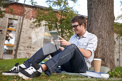 Image of happy teenage boy with tablet pc and coffee