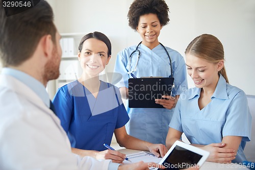 Image of group of happy doctors meeting at hospital office