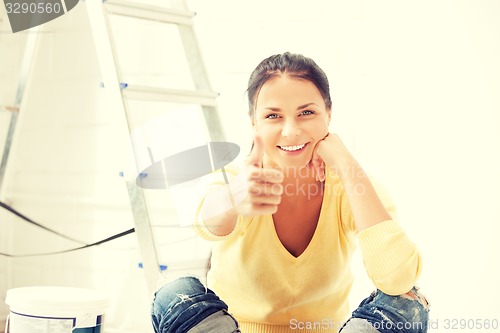 Image of lovely housewife making repairing works