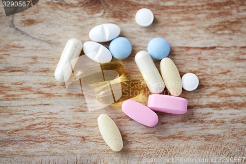 Image of pills and omega 3 oil capsules on table