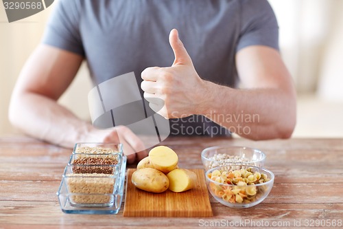 Image of close up of male hands with carbohydrate food