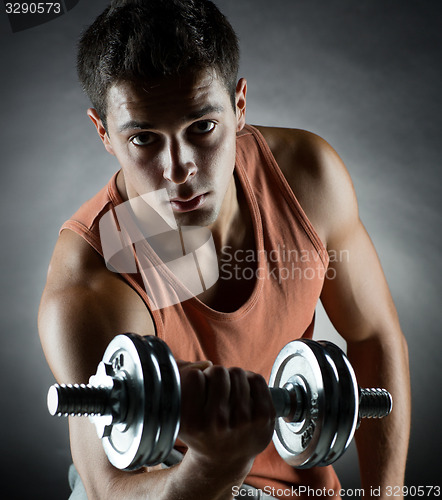 Image of young man with dumbbell