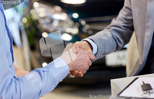 Image of close up of male handshake in auto show or salon