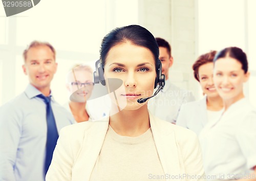 Image of helpline operator with headphones in call centre