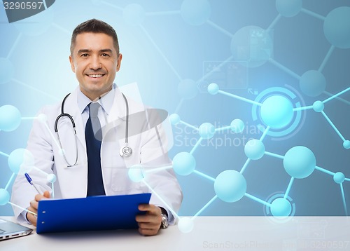 Image of happy doctor with clipboard over blue background