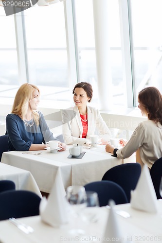 Image of women drinking coffee and talking at restaurant