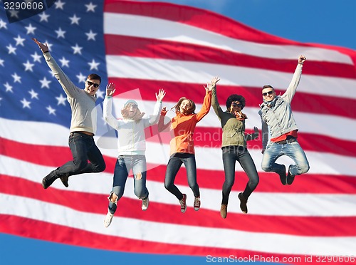 Image of smiling friends in sunglasses jumping high