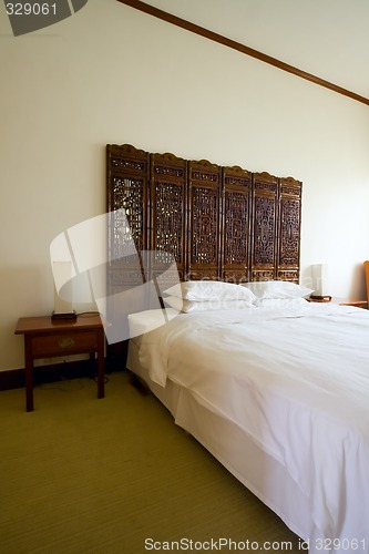 Image of Queen sized bed in a hotel room


