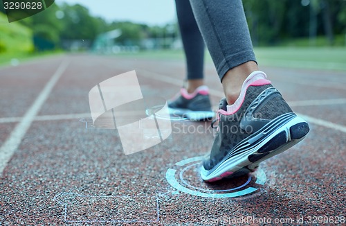 Image of close up of woman feet running on track from back