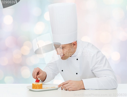 Image of happy male chef cook decorating dessert