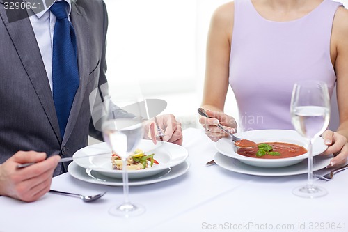 Image of close up of couple eating appetizers at restaurant