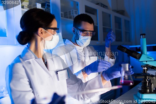 Image of close up of scientists making test in lab