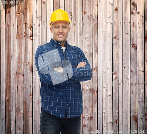 Image of smiling male builder or manual worker in helmet