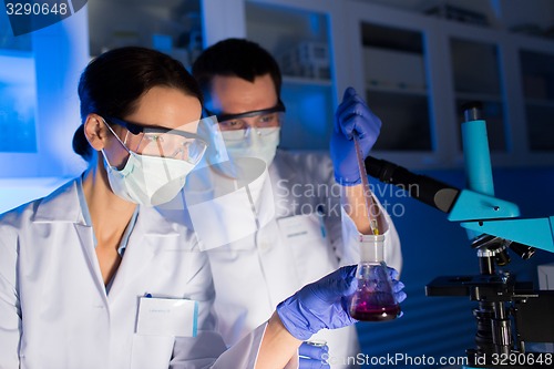 Image of close up of scientists making test in lab