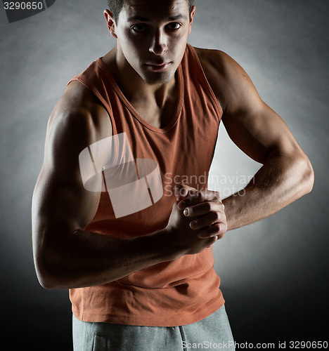 Image of young man showing biceps