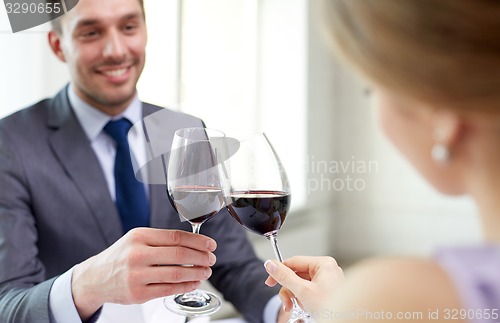 Image of happy couple with glasses of wine at restaurant