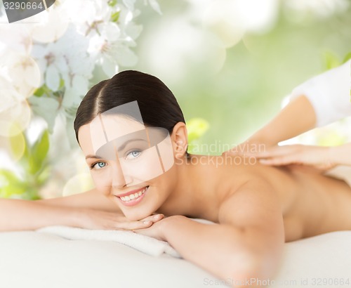 Image of happy beautiful woman having back massage